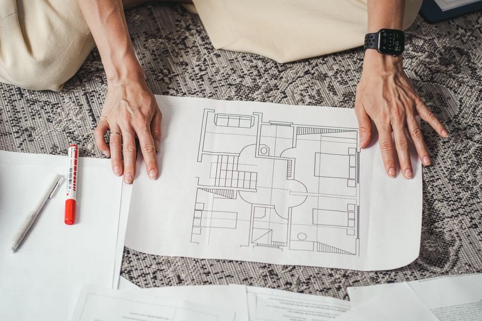 Architect working on a sustainable building blueprint with solar energy icons