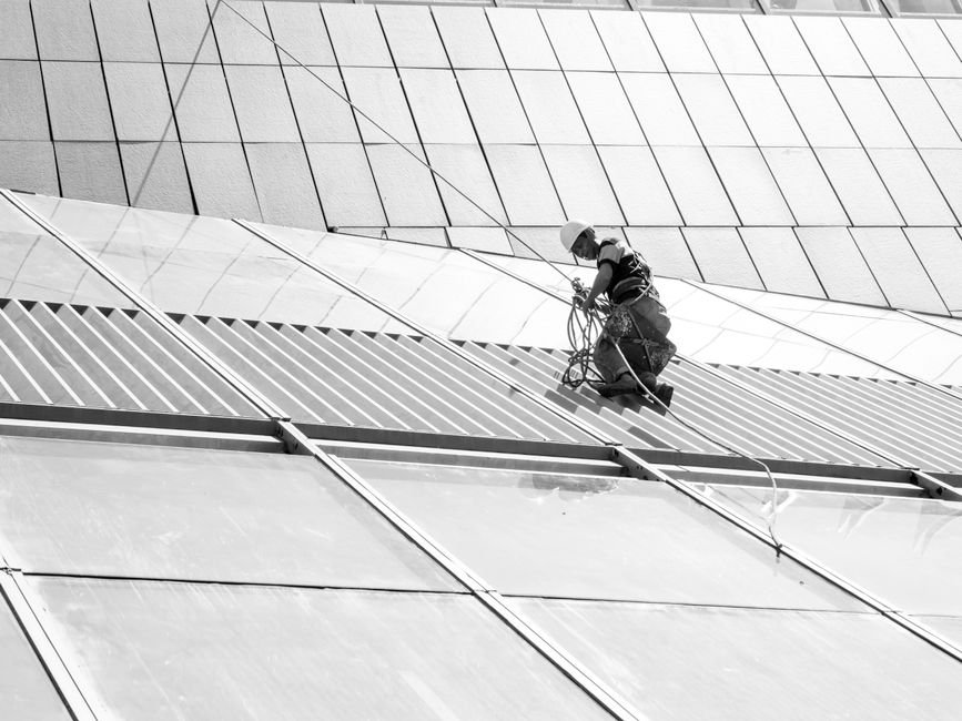 construction safety workers wearing helmets and harnesses