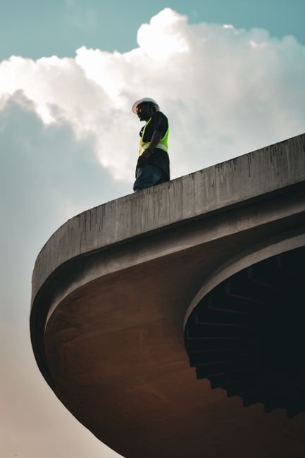 construction workers inspecting green concrete structure on a modern site