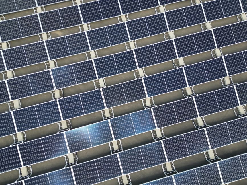 electrical engineers working at a large solar farm in desert