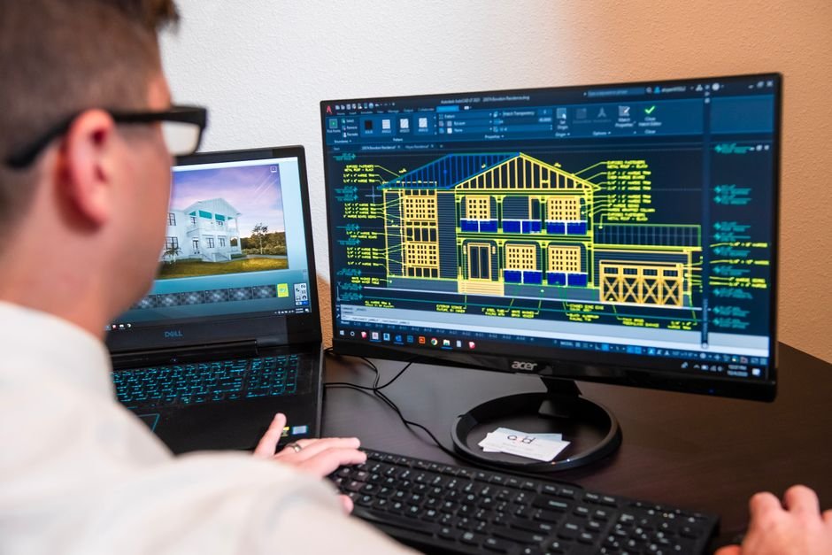 engineers reviewing 3D building model on computer screen