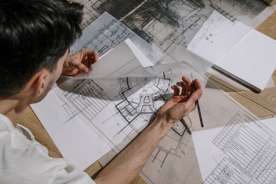 engineers reviewing construction blueprints of a modern solar plant and battery system in Mexico