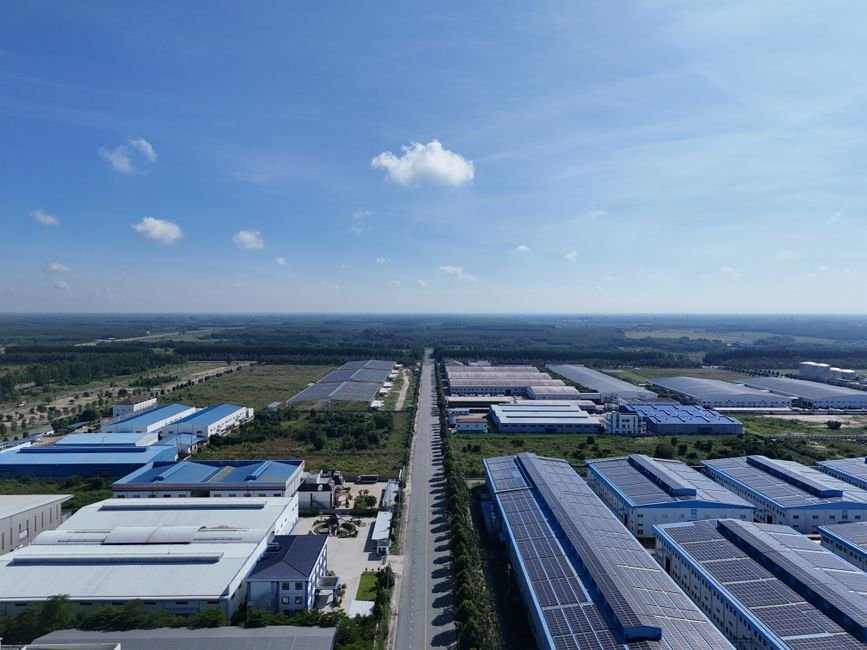 industrial solar panels on large factory roof in desert landscape