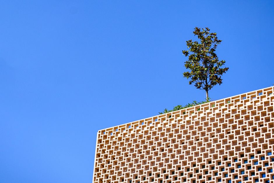 Modern bioclimatic building facade in desert landscape with sustainable architecture features