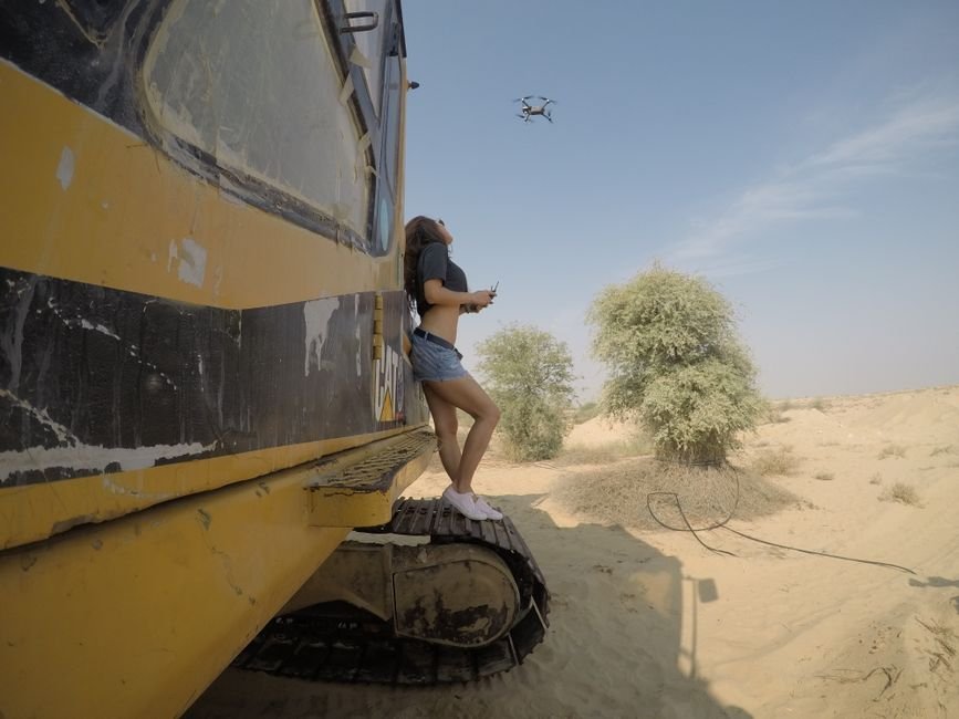 modern construction equipment operating in sunny desert landscape