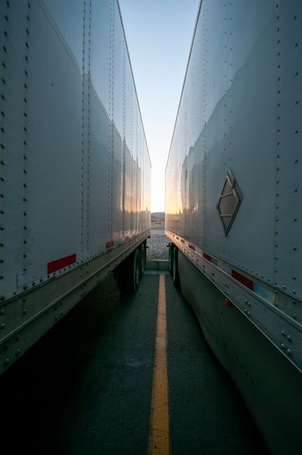 Modern industrial park with logistics trucks in a desert landscape