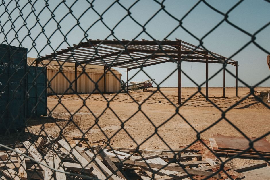 Modern industrial warehouse construction site with steel structure in desert landscape