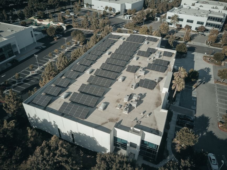 Modern solar panels installation on a commercial building rooftop in Mexico with desert background