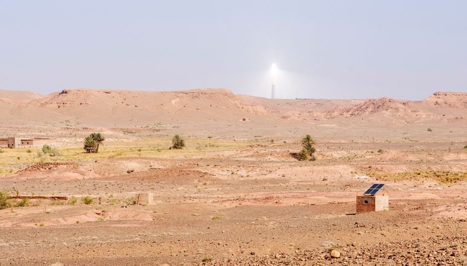 solar panels and electrical inverter substation in desert landscape
