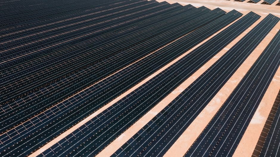 Aerial view of a large solar farm installation in the Sonoran desert during construction