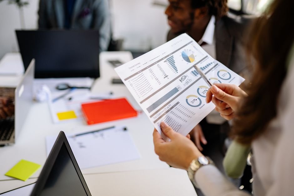 business people reviewing architectural plans and financial charts
