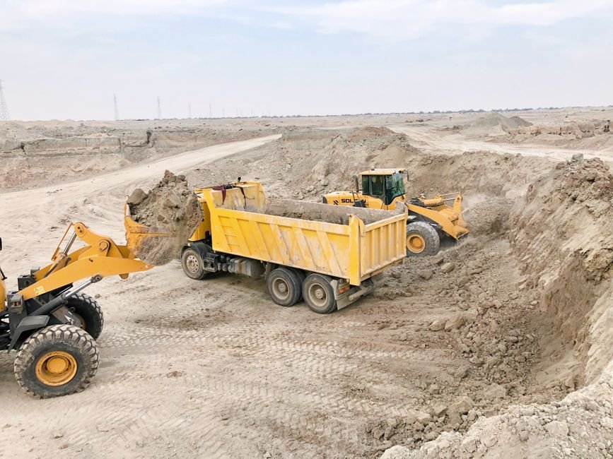 civil engineer analyzing soil sample on construction site in desert
