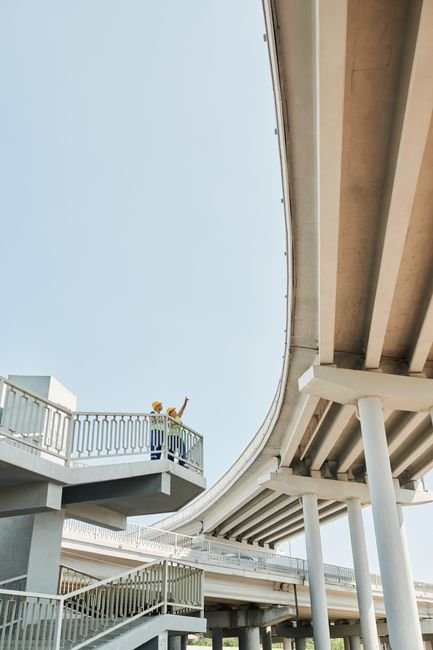 civil engineers inspecting a newly paved concrete road construction site