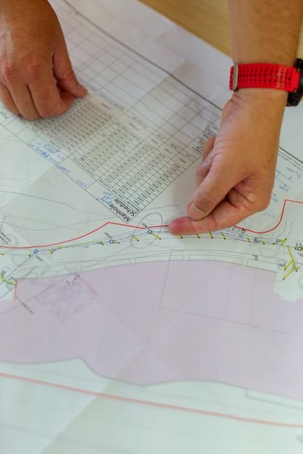 Engineers reviewing blueprints at a major border highway construction site in Sonora