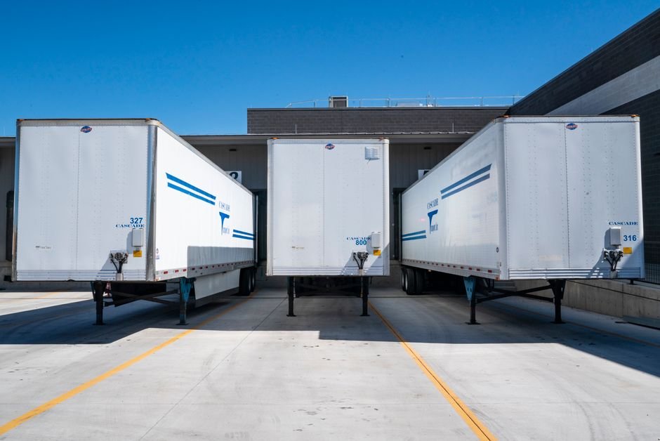 Modern border crossing facility with commercial trucks and industrial architecture