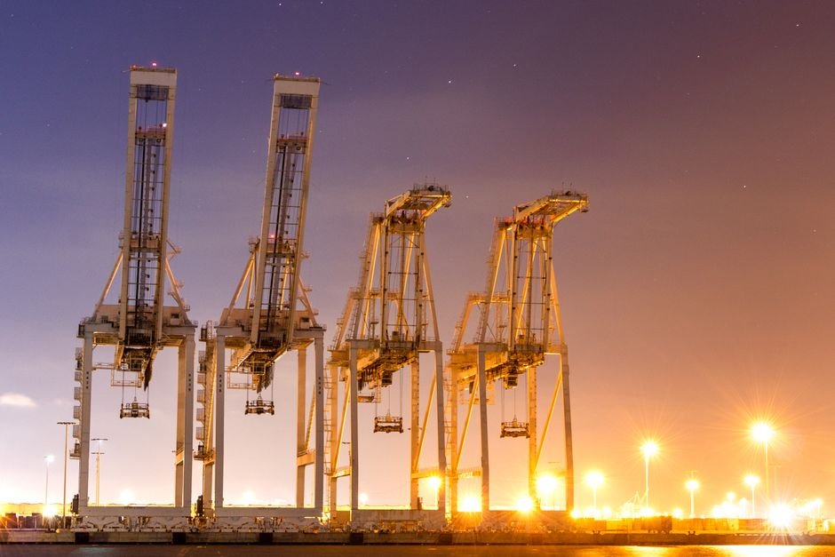 Modern cargo port facility with container cranes and large ships in Mexico