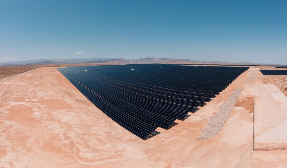 modern sustainable commercial building in arid desert landscape with solar panels
