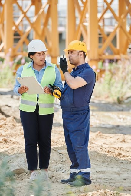 engineers inspecting construction site of advanced technology facility with blueprint