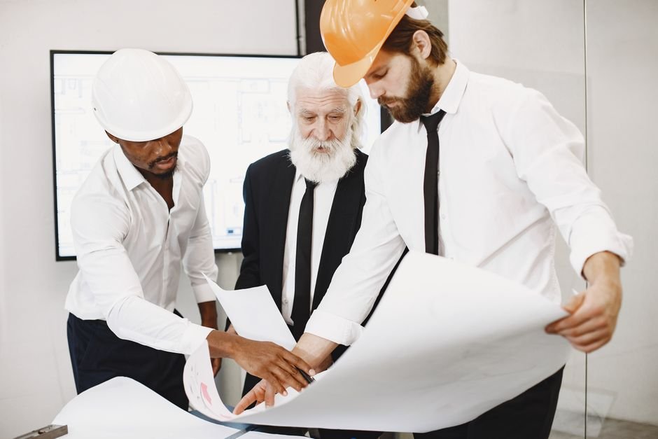 engineers reviewing architectural blueprints of water infrastructure project in the desert