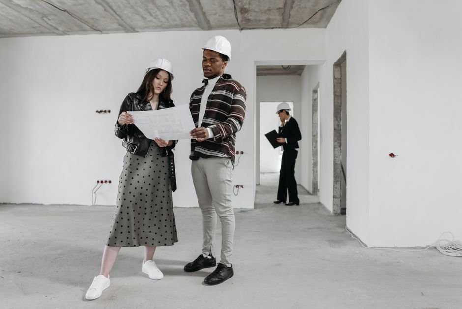 Engineers reviewing architectural blueprints on a modern construction site