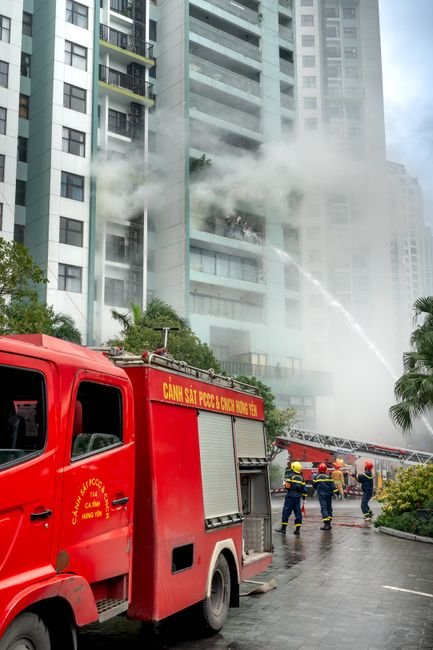 firefighters and engineers inspecting fire suppression system in high-rise building under construction