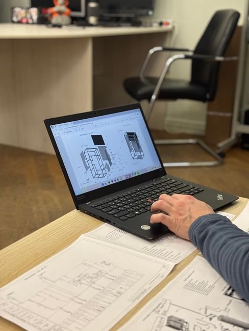 Mining engineers analyzing digital blueprints and drilling patterns in a tunnel