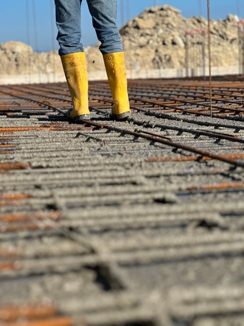 construction workers inspecting bridge foundation and concrete piers