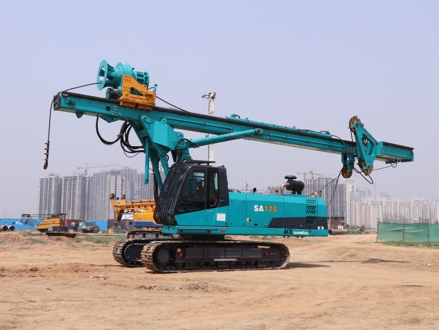 deep foundation drilling rig operating at a large scale mining site in desert terrain