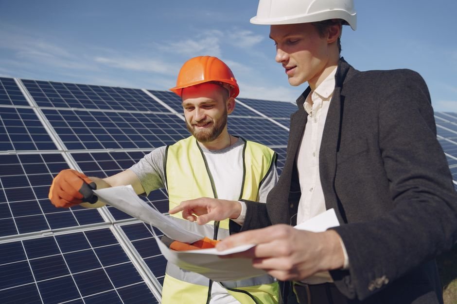 engineers reviewing construction plans at a solar power plant site