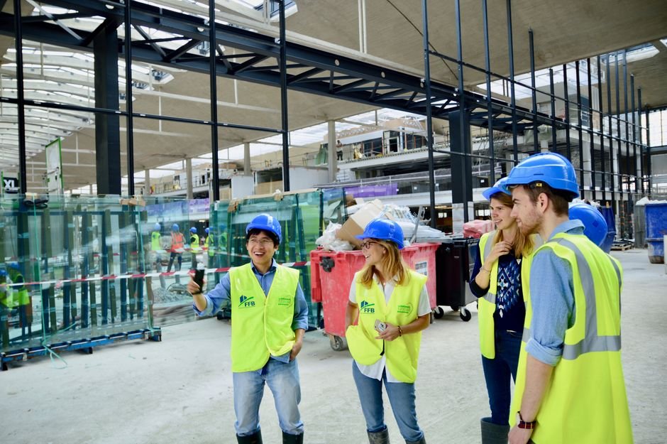 modern fuel station construction site with engineers in hard hats