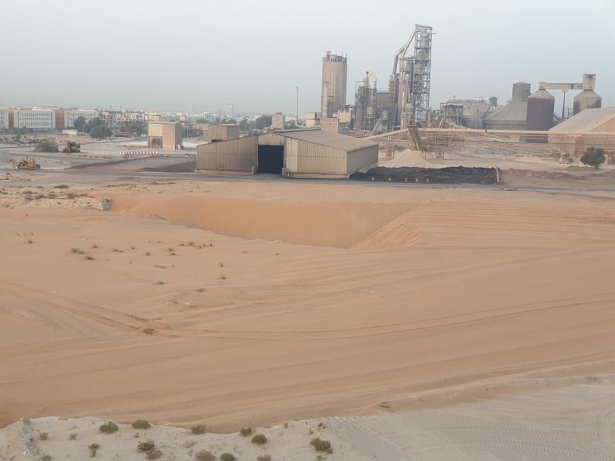Modern industrial processing plant for mineral extraction with large steel structures in a desert valley